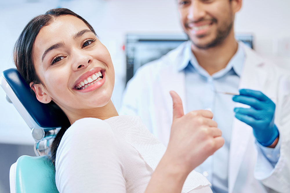 dental patient giving thumbs up