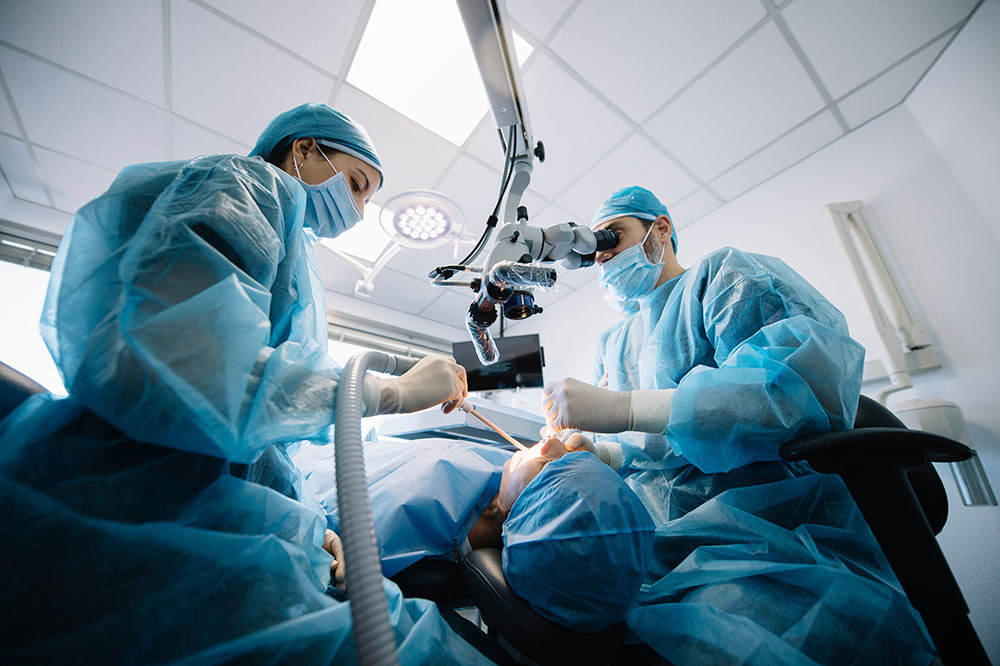 dentist performing oral surgery patient