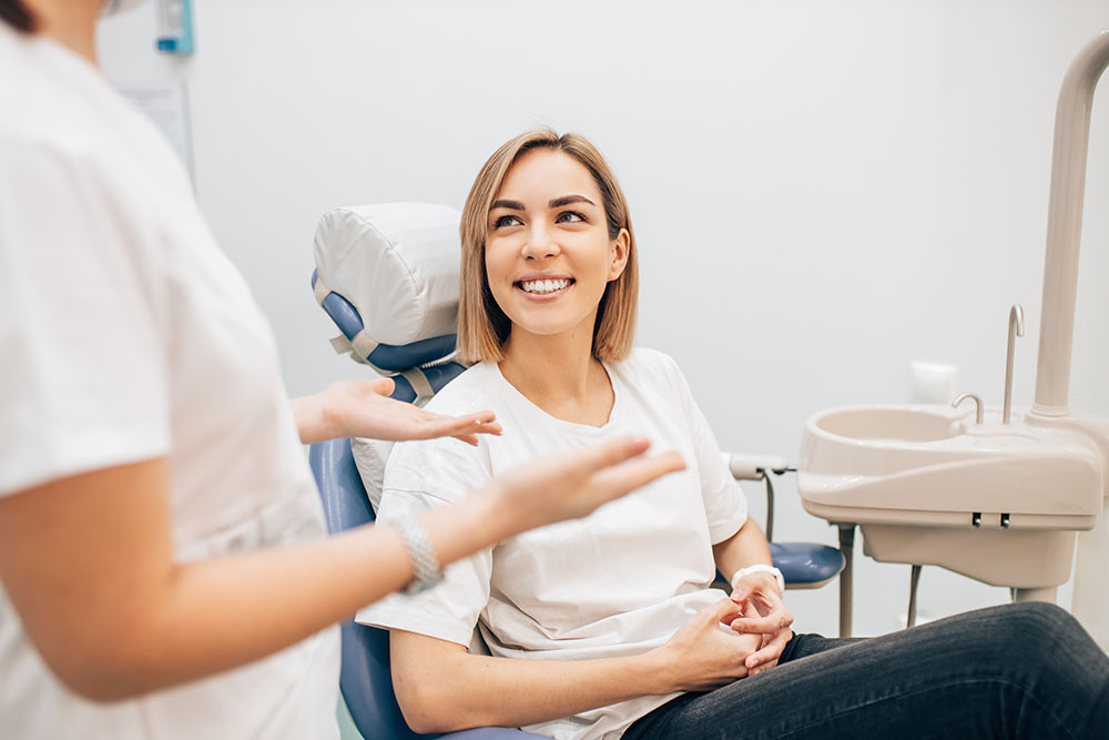 young beautiful lady with blond short hair sit in dentist office, waiting for a teeth treatment.