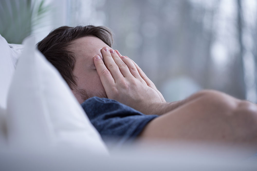 Man having some sleeping disorders like insomnia